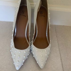 White spiked heeled pumps